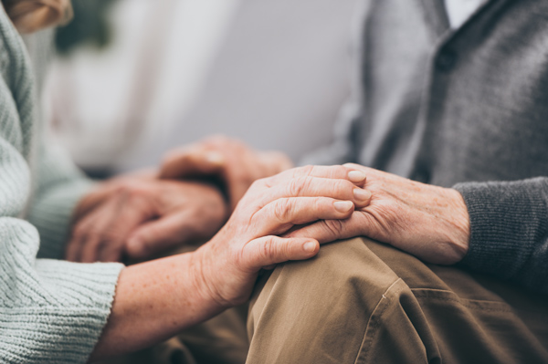 home care business in West Midlands and Walsall elderly couple holding hands in knitted jumpers